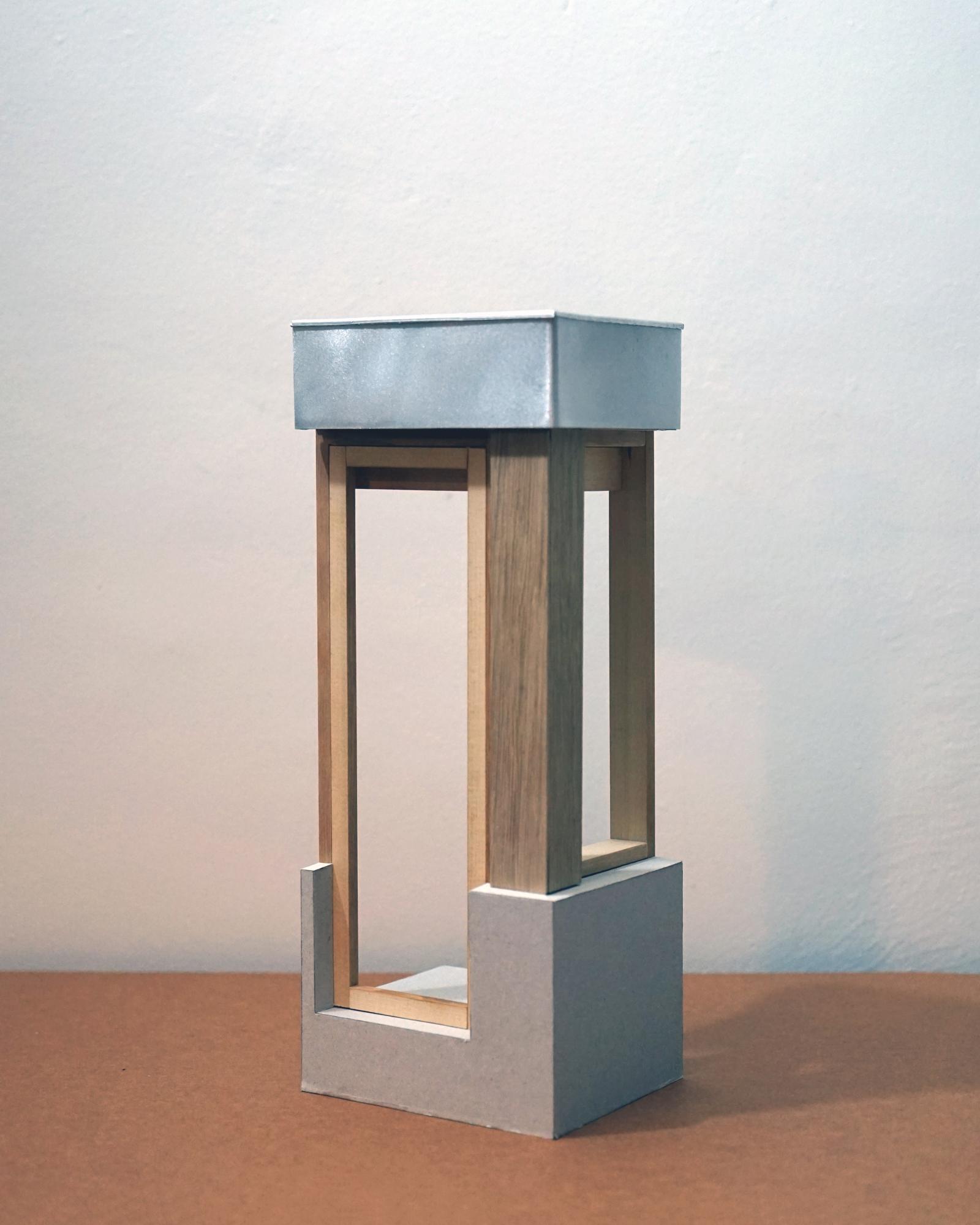 House for Astrid and Freddie, 1.10, Construction Model
This model was made to test the junctions, layers and material relationships that underpin the architectural idea of the house. Working at 1:10 allowed structural depth, fixing logic and tolerances to be explored with enough precision to confront how the building would actually be assembled.

The model was used to examine how timber structure, enclosure and heavier base elements meet, and how architectural intention survives contact with construction reality. Joints were adjusted through making, not only to resolve buildability but to understand how thickness, reveal and alignment contribute to the spatial character of the house. The act of assembling the model exposed moments of friction between abstraction and material fact, helping to refine both.

For the viewer, the model makes legible the translation from idea to contemporary construction. It shows how the house is composed of layers rather than surfaces, and how architectural form emerges through decisions about connection, support and sequence. The model foregrounds construction as a formative process, where material reality is not a constraint on design but a means of sharpening it.

Handmade in timber, card, foam and aluminium

Benjamin Machin and Lewis Foster-Jeapes, Architectural Assistant