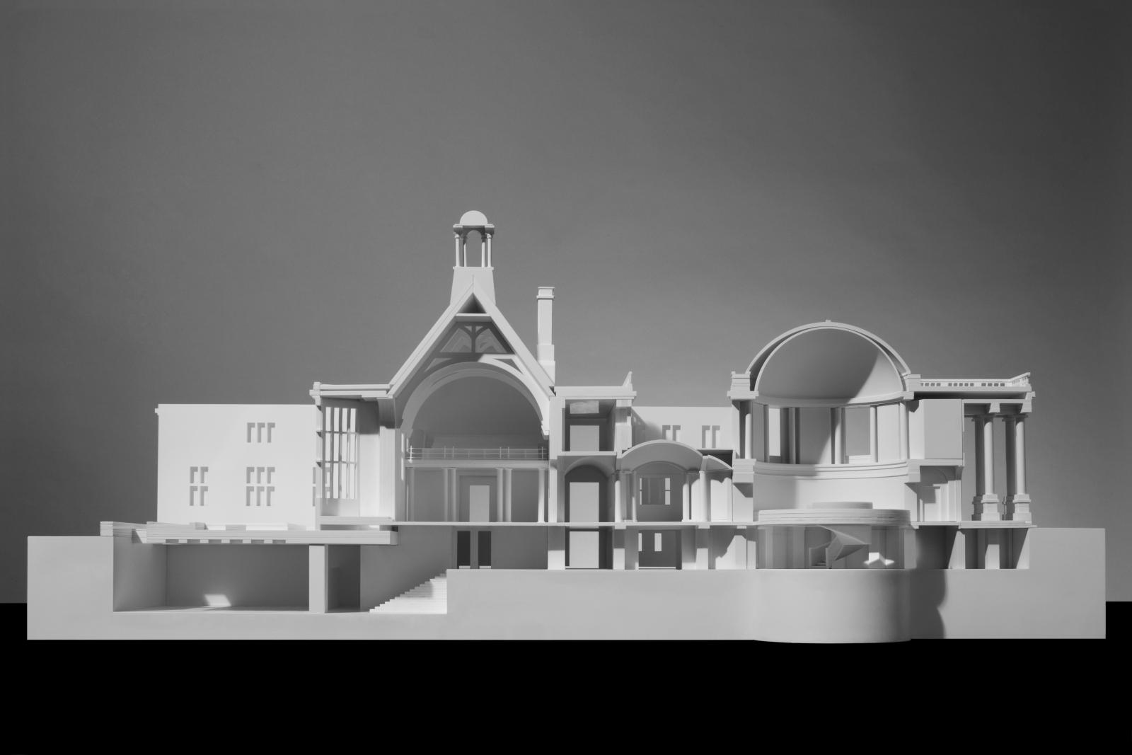 Rhodes House, University of Oxford, 1:75, Sectional Competition Model

This model was developed for a design competition proposal for Rhodes House and was produced through a collaborative process involving modelmakers and architectural staff working in parallel. A range of techniques were used, including laser cutting, workshop machining, spray finishing, and the modelling and 3D printing of the proposed new spiral stair. Careful coordination was required to represent the complex geometry and multiple levels of this historic building. The model was used to explain the key interventions and the principal route through the reconfigured building.

Stanton Williams won the competition and developed the scheme in close collaboration with the Rhodes Trust and the wider design and construction team. The project transforms Rhodes House and its gardens through significant yet respectful interventions that complement Herbert Baker’s original architecture. The scheme doubles the building’s usable space and substantially improves environmental performance, while carefully restoring the 1920s building and historic gardens.

The site has been reorganised to establish clear circulation routes, with new conference facilities at its heart. At the centre of the Rotunda, a new sculptural staircase leads to transformed lower floors, including a 300-seat Conference Hall and Foyer created within former archive spaces. Glazed lightwells bring daylight, fresh air and views of the gardens into these new interior spaces. 

Acrylic, Chemiwood, Paint and 3D print

Model Making Team

Stephen Setford
Artemis Antonopoulou
Sam Collins
Andrew Morris
Jaesung Kim

Design Team

Paul Williams
Stephen Hadley
Tom Fotheringham
Andrew Morris