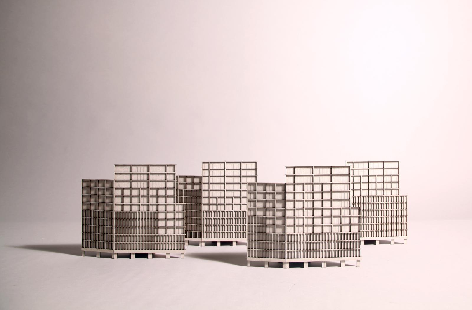 The Republic, Mayfield, Manchester | 1:250 | Facade / Composition Study x4

This series of repeated tests at 1:250 focuses on one part of 'The Republic' a HQ Workplace in Manchester, planned as phase 1 of the Mayfield Park regeneration project for Landsec U+I. These miniature models, formed through a process of hand-folded card and laser cut compositional studies, explore the building concept of lightly wrapped built fabric, around a highly sculpted block. Each study tests the change in facade bay type, of which we identified three, resulting in a variety of readings of weight and lightness; according to the rhythm and spacing of primary vertical metal extruded fins, and horizontal secondary elements. The models explore a primary corner to a main facade, and the steps it takes to meet the secondary facade. These model studies were pivotal in our design evolution and decision making.

Card. Handmade and lasercut.

Made by Morris+Company