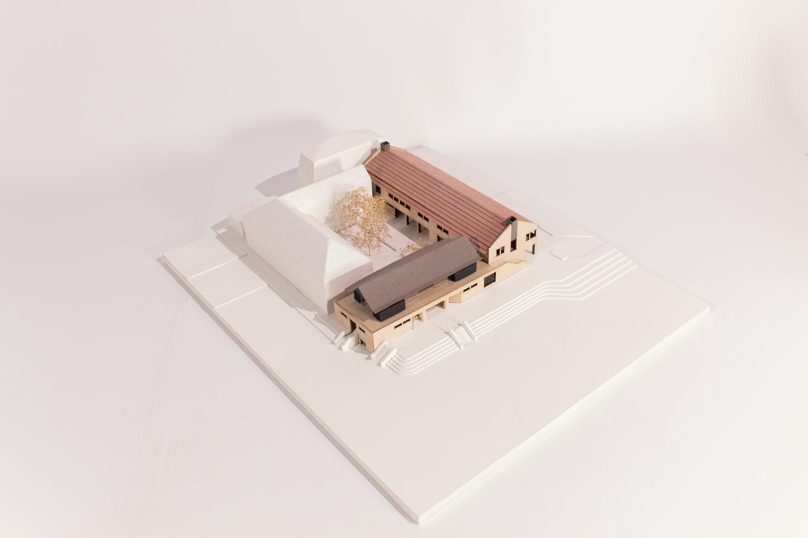 Manchester Grammar School, Sixth Form Centre & Sports Pavilion / Scale: 1:200 / Type : Presentation Model

The model is a representation of a new Sixth Form Centre and Sports Pavilion for the Manchester Grammar School.  The building is an ‘L’ shape in plan, enclosing a new courtyard by mirroring an existing classroom building.
 
The project consists of classroom and pavilion wings, and the model reflects the project as it was at a relatively late stage of its design development.  It was produced primarily as a tool to explain scale and form to the client as well as wider stakeholders.
 
Whilst remaining partially abstract, the scale and materials used were chosen to reflect proposed materiality and texture to communicate these decisions to a ‘non-architectural’ audience.  The adjacent buildings are left as simple masses, reflecting the audience’s familiarity with these existing structures.

Laser cut ply, foam board, wood, brass, card

Made by Jamie Reed (Architectural Assistant) 
Project team: Andy James (Director), Philip Etchells (Associate Director), Christopher Wells (Senior Architect)
