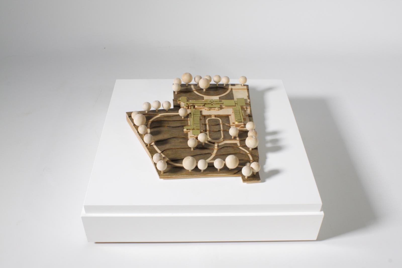 Diagrammatic Model - ‘A Monastery in the City’, Harborne, Birmingham - Manresa House / Scale: 1:500 / Type : Concept Model

The project represented is the modification and extension of an existing noviciate (priest training) at Manresa House, Birmingham.  The design principles echo traditional monastic arrangements by forming a series of accommodation wings radiating out from the retained villa and framing an open courtyard space to the rear and a formal and symmetrical frontage.
 
The model was produced primarily as a physical record of a very specific design process, and as such, it is primarily diagrammatic, showing the underlying basis of the building’s plan and its relationship to its site. 
 
The materials and applied finishes were deliberately chosen to highlight the plan-form, making legible the order and distribution of spaces in contrast to more visible architectural decisions such as mass, materiality, or structure.
 
The model has been more of a display piece as opposed to a design tool, an abstract but physical representation of a primarily drawing-based and developed design process.

Laser cut and etched plywood, varnish, hand cut brass 

Made by Philip Etchells (Associate Director)
Project team: Andy James (Director), Christopher Wells (Senior Architect), Benjamin Carter (Architectural Assistant) 