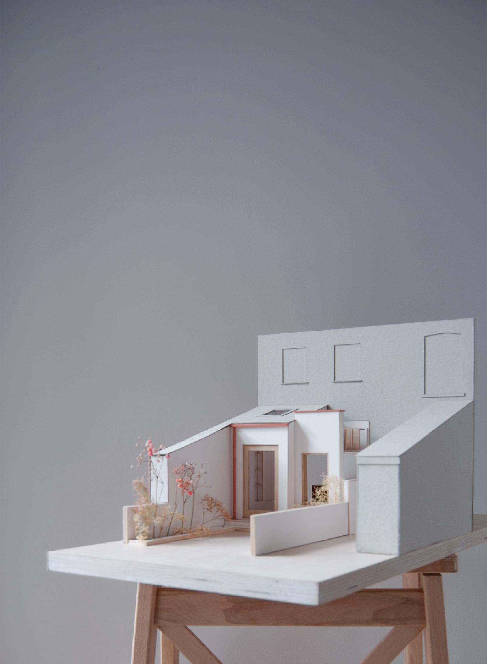 Extension to an Edwardian terraced house, Cheadle Village, 1:25, Interior and exterior model.

The exterior model was used to test the relationship of the extension to the existing Edwardian house and its immediate context. It also explores materiality; using white card for the proposed white painted brickwork and render, terracotta paint to pick out the detailing of the metalwork, and balsa wood for the timber framed windows.

Internally, the model was used to design the kitchen and dining area, exploring daylighting and atmosphere in the space.

Card, balsa and plywood

Made by Jay Mistry and Eleanor Swire, Directors