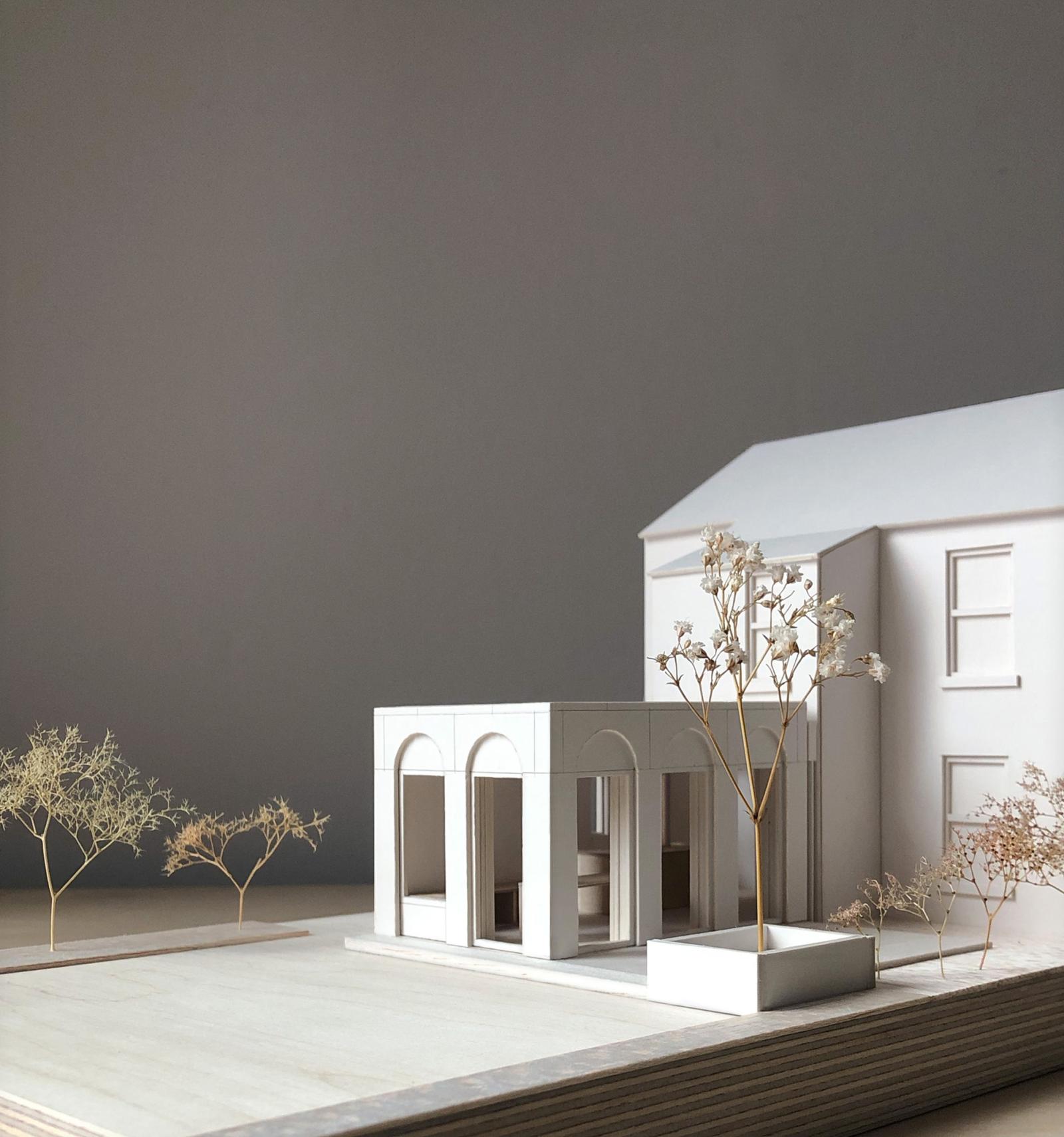 Extension to a Victorian Villa, Heaton Moor, 1:50.

The villa, located in the Heaton Moor conservation area, is an elegant and substantial period property with feature arched windows to its frontage.

The model was used to test proposals for a new extension that would harmonise with the original property and add to its distinctives. 

The arched façade establishes continuity and lends the new building a feeling of lightness and height with a pavilion-like character.

The interior space has also been modelled, to explore spatial qualities and test opening locations for daylighting and views out to the garden.

Card, balsa and plywood

Made by Jay Mistry and Eleanor Swire, Directors